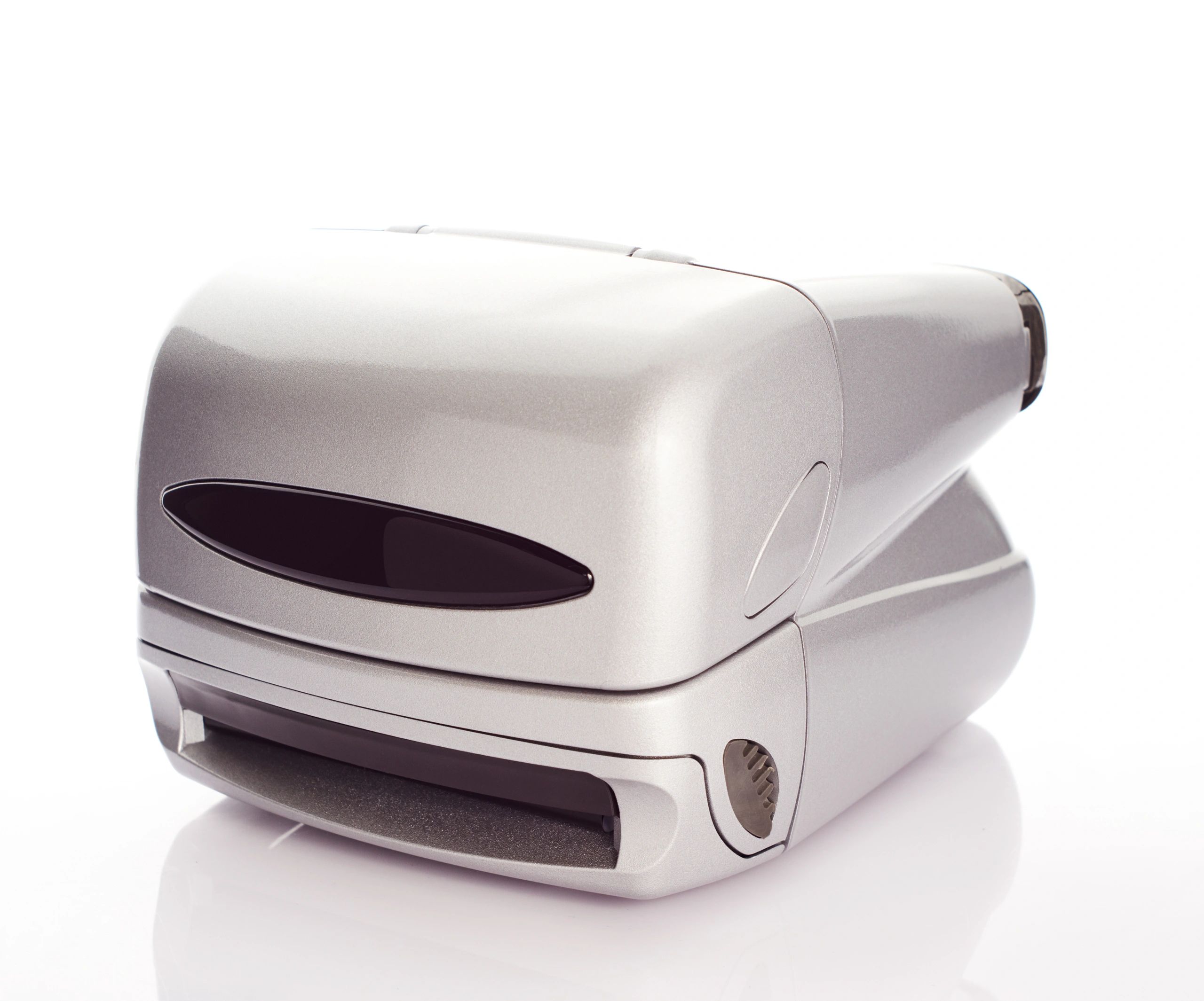 Metalic silver colored Instant film camera from 90's on white background